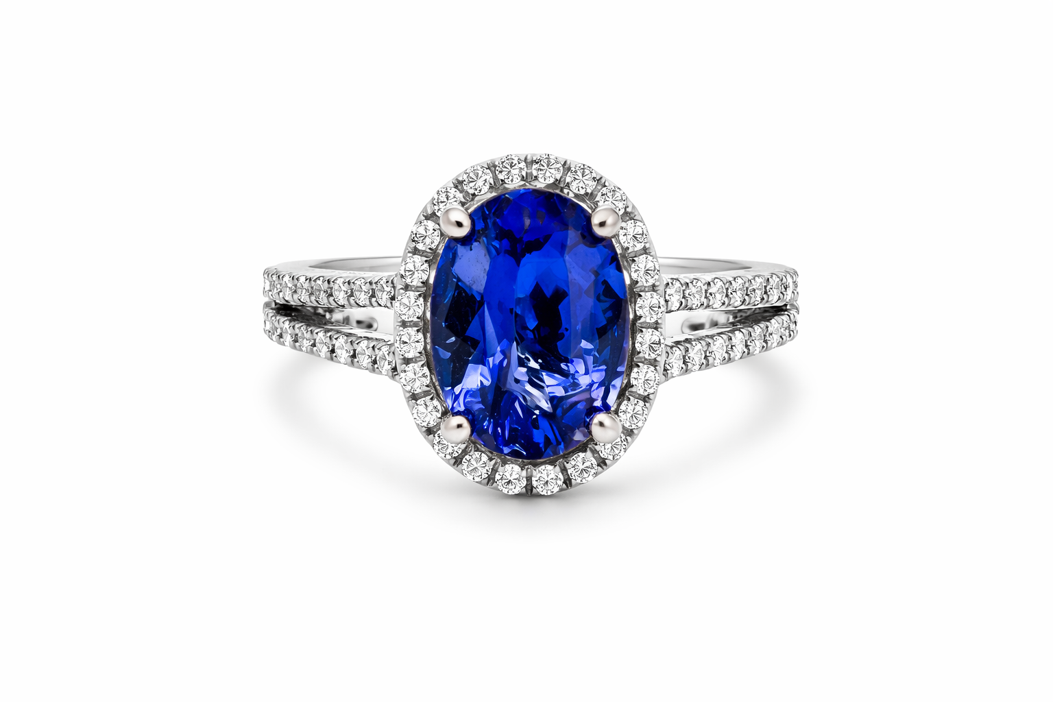 Ring with a tanzanite gemstone and diamond-studded band on a white background