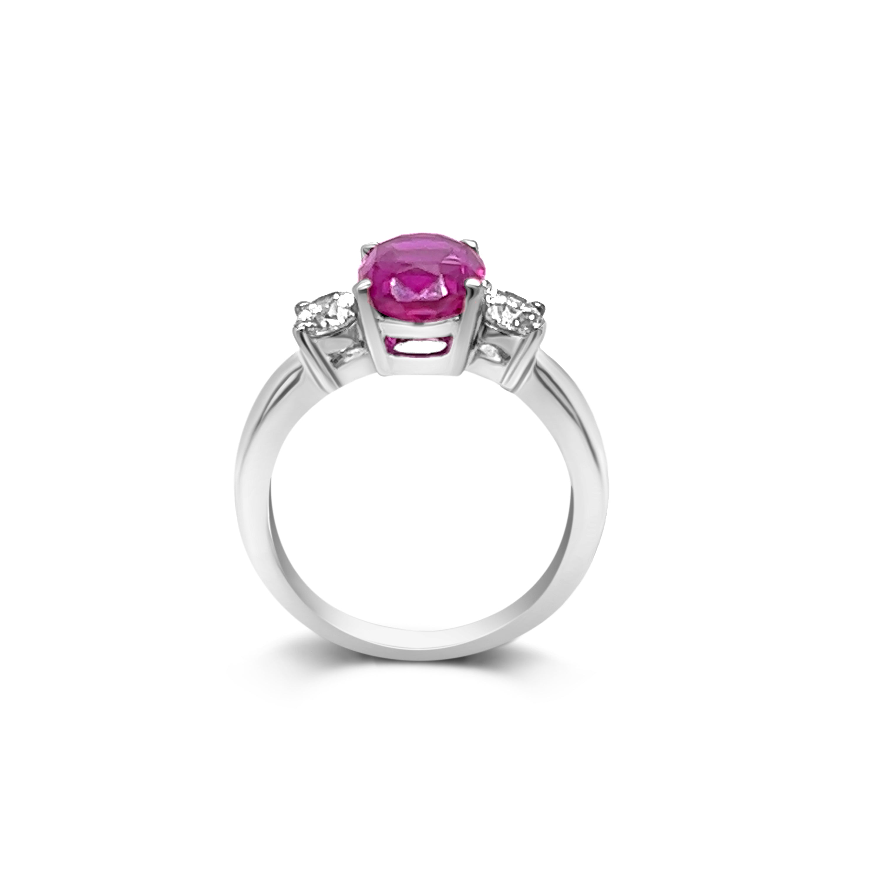 Center view of three-stone pink sapphire and diamond ring in 14kt white gold - 2.99 ct pink sapphire, 0.50 ct round diamonds - timeless elegance and romance.