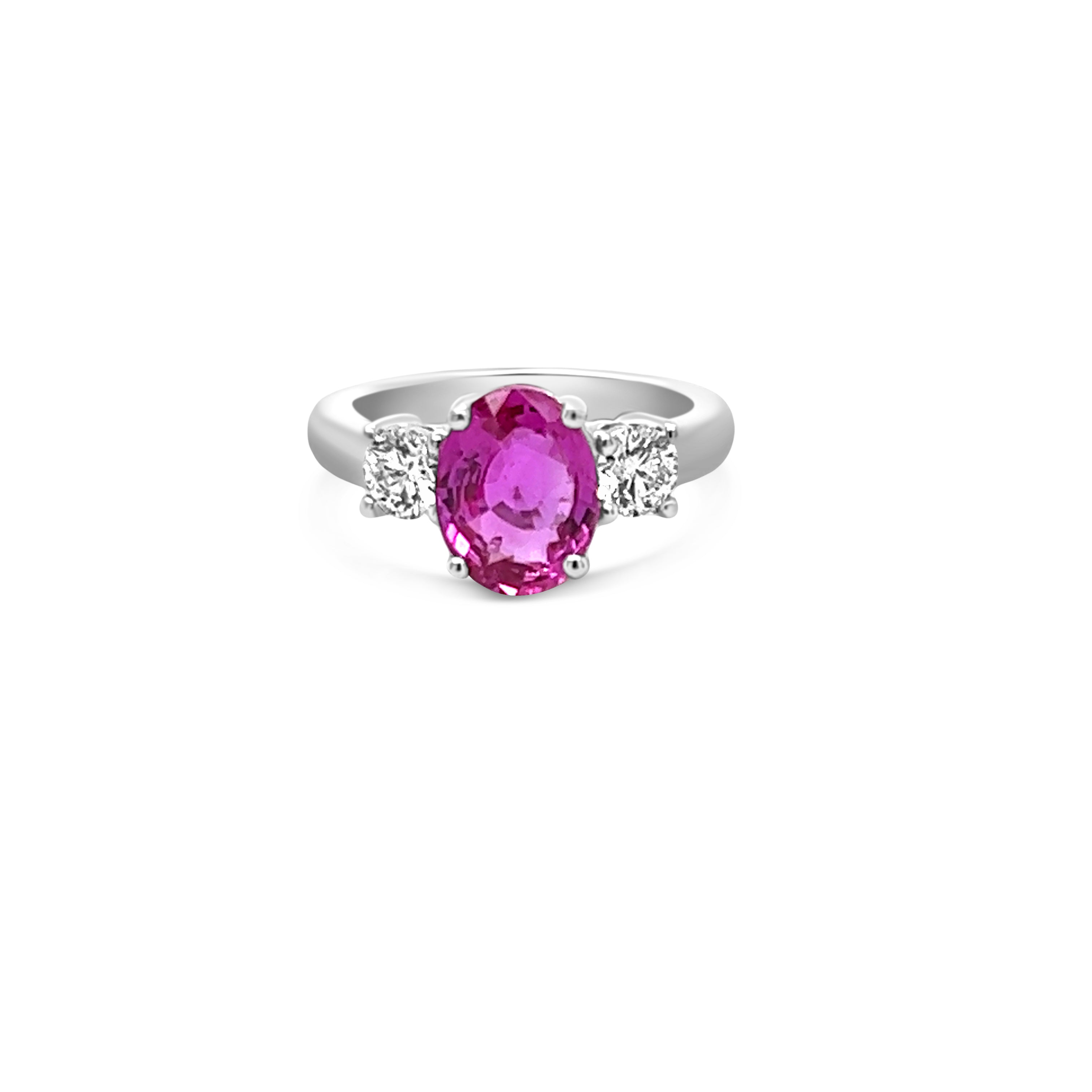 Center view of three-stone pink sapphire and diamond ring in 14kt white gold - 2.99 ct pink sapphire, 0.50 ct round diamonds - timeless elegance and romance.