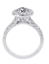 Side view of unique 14kt white gold round diamond halo engagement ring with a split shank and side diamond heart design beneath a halo.