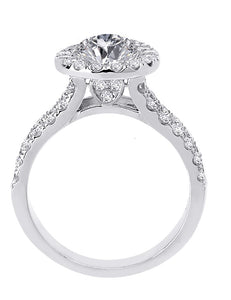 Side view of unique 14kt white gold round diamond halo engagement ring with a split shank and side diamond heart design beneath a halo.